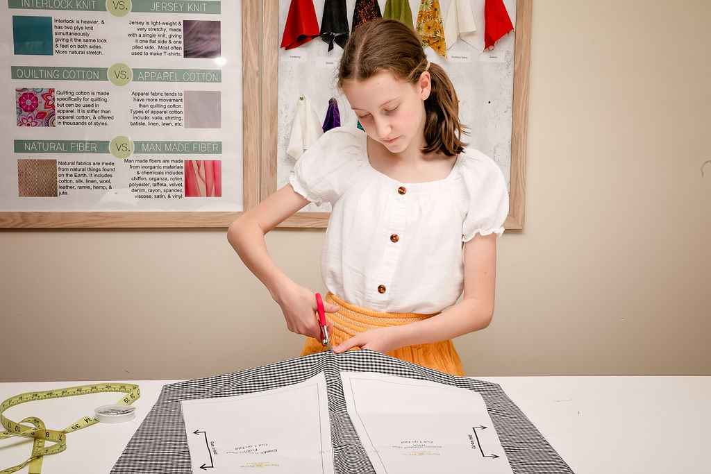 Girl learning how to sew